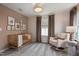 Bedroom featuring crib, rocking chair, neutral color scheme and window at 700 Ben Ledi Ct, Raleigh, NC 27603