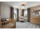Bedroom featuring crib, natural color scheme, rocking chair and window at 700 Ben Ledi Ct, Raleigh, NC 27603
