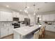 Gourmet kitchen features a large central island, stainless steel appliances, and elegant white cabinetry at 700 Ben Ledi Ct, Raleigh, NC 27603