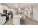 Bright, open kitchen featuring white cabinets, stainless steel appliances, and a large island with bar seating at 700 Ben Ledi Ct, Raleigh, NC 27603