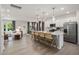 Open-concept kitchen with stainless steel appliances, a large island with seating, and hardwood flooring at 700 Ben Ledi Ct, Raleigh, NC 27603