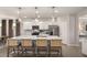 Spacious kitchen island with quartz countertop and pendant lighting; modern stainless-steel appliances and white cabinetry at 700 Ben Ledi Ct, Raleigh, NC 27603