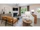 Cozy living room featuring a fireplace, large windows, and stylish furnishings at 700 Ben Ledi Ct, Raleigh, NC 27603