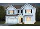 Charming two-story home with white siding, black shutters and a welcoming front porch and attached garage at 712 Ben Ledi Ct, Raleigh, NC 27603