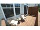 Cozy townhouse balcony featuring comfortable chairs, a side table, and views through large windows at 713 Traditions Grande Blvd, Wake Forest, NC 27587