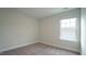 Cozy bedroom with neutral carpet and a window offering natural light at 713 Traditions Grande Blvd, Wake Forest, NC 27587