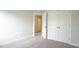 Well-lit bedroom with carpet flooring and a closet for ample storage at 713 Traditions Grande Blvd, Wake Forest, NC 27587