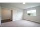 Spacious bedroom with cozy carpet, a window and an entrance to another room at 713 Traditions Grande Blvd, Wake Forest, NC 27587