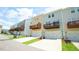 Townhouse exteriors with garages and balconies under a blue sky at 713 Traditions Grande Blvd, Wake Forest, NC 27587