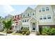 Charming townhome exterior featuring colorful facade and landscaped front yard at 713 Traditions Grande Blvd, Wake Forest, NC 27587