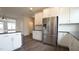 Contemporary kitchen with stainless steel appliances, white cabinets and backsplash at 713 Traditions Grande Blvd, Wake Forest, NC 27587