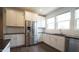 Modern kitchen with stainless steel appliances, granite counters, and white cabinetry at 713 Traditions Grande Blvd, Wake Forest, NC 27587