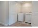 Bright laundry room featuring a washer, dryer, and wire shelving for organized storage at 713 Traditions Grande Blvd, Wake Forest, NC 27587