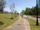 Paved community path surrounded by trees and greenery at 713 Traditions Grande Blvd, Wake Forest, NC 27587