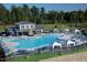 Community pool featuring lounge chairs, cabanas, splash pad and outdoor clubhouse at 713 Traditions Grande Blvd, Wake Forest, NC 27587