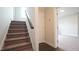 Carpeted staircase leading to the upper level of the home with wood railing at 713 Traditions Grande Blvd, Wake Forest, NC 27587
