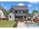 A lovely backyard features a stunning pool, lounge chairs, a deck and beautiful green space at 800 Wilcox St, Raleigh, NC 27607
