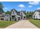Striking exterior view showcasing a spacious driveway, manicured lawn, and elegant architectural design at 800 Wilcox St, Raleigh, NC 27607