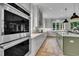 Gourmet kitchen with stainless appliances, white cabinets, and spacious countertops at 800 Wilcox St, Raleigh, NC 27607