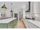 Modern kitchen with stainless steel appliances, center island with seating, and an open floor plan at 800 Wilcox St, Raleigh, NC 27607