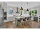 Bright kitchen features a large island with counter seating, stainless steel appliances, and hardwood floors at 800 Wilcox St, Raleigh, NC 27607