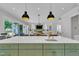Open kitchen and living space with a large island, stainless steel appliances, and modern lighting at 800 Wilcox St, Raleigh, NC 27607