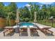 Relaxing pool area featuring comfortable lounge chairs, umbrellas, and beautiful landscaping at 800 Wilcox St, Raleigh, NC 27607
