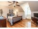 Bedroom featuring a sloped ceiling, hardwood floors, and a cozy beanbag chair at 820 Parkridge Dr, Clayton, NC 27527