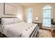 Bright bedroom with an arched window, stylish decor, and neutral color palette at 820 Parkridge Dr, Clayton, NC 27527