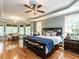 Spacious bedroom with hardwood floors, ceiling fan, and a sitting area in a bay window at 820 Parkridge Dr, Clayton, NC 27527
