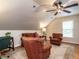 Comfortable bonus room with carpet, a seating area, and a ceiling fan at 820 Parkridge Dr, Clayton, NC 27527