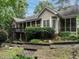 Beautiful backyard exterior view of the home featuring a porch, patio, and well-manicured landscaping at 820 Parkridge Dr, Clayton, NC 27527