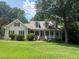 Charming home with a welcoming front porch, lush lawn, and mature trees at 820 Parkridge Dr, Clayton, NC 27527