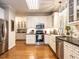 Bright kitchen featuring white cabinets, stainless steel appliances, and a breakfast bar at 820 Parkridge Dr, Clayton, NC 27527