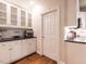 Additional view of the kitchen area with white cabinets and a door to another room at 820 Parkridge Dr, Clayton, NC 27527