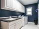 Functional laundry room with washer, dryer, and ample storage space at 820 Parkridge Dr, Clayton, NC 27527