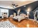 Bright main bedroom features wood floors, blue walls, and a sitting area at 820 Parkridge Dr, Clayton, NC 27527