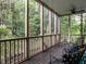 Screened porch surrounded by mature trees and foliage at 820 Parkridge Dr, Clayton, NC 27527