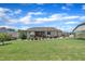 Expansive backyard boasts a large lawn, landscaping, patio and greenhouse at 85 Willard Wood Run, Benson, NC 27504