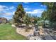 Landscaped backyard with a lighthouse ornament surrounded by gravel and trees at 85 Willard Wood Run, Benson, NC 27504