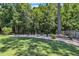 Large backyard with manicured lawn, landscaping, and a variety of trees and shrubs at 85 Willard Wood Run, Benson, NC 27504