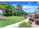 Sprawling backyard featuring lush green grass and a paver walkway at 85 Willard Wood Run, Benson, NC 27504