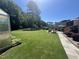 Expansive backyard featuring a well-maintained lawn, mature trees, and a charming patio area for outdoor enjoyment at 85 Willard Wood Run, Benson, NC 27504