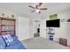 Bedroom featuring a blue couch, a bookshelf, and a mounted TV at 85 Willard Wood Run, Benson, NC 27504