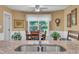 Bright dining area with a ceiling fan, plants, and a view of the backyard at 85 Willard Wood Run, Benson, NC 27504