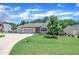 Lovely one-story home with attached two car garage and a lush front lawn and driveway at 85 Willard Wood Run, Benson, NC 27504