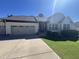 Charming single-story home boasts an attached two-car garage and a well-manicured front lawn with landscaping at 85 Willard Wood Run, Benson, NC 27504