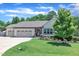 Charming single-story home with a well-manicured lawn, landscaped flowerbeds, and a two-car garage at 85 Willard Wood Run, Benson, NC 27504