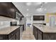 Modern kitchen featuring stainless steel appliances, dark cabinets, and granite countertops at 85 Willard Wood Run, Benson, NC 27504