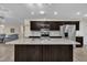 Open-concept kitchen with a large island, stainless steel appliances, and dark cabinets at 85 Willard Wood Run, Benson, NC 27504